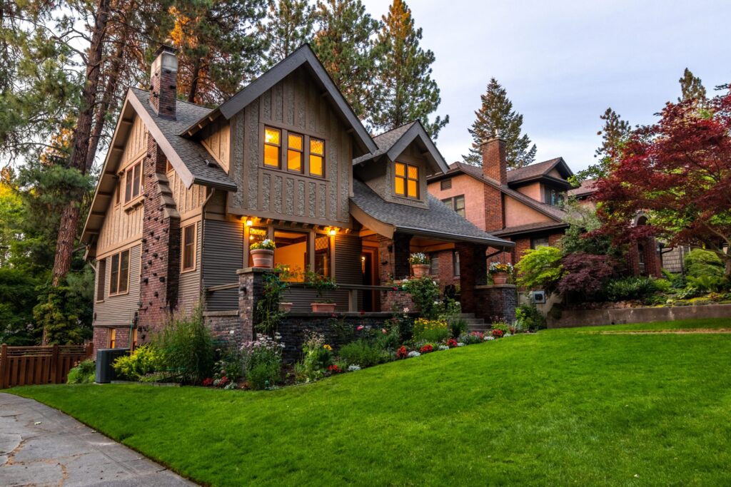 brown concrete house near green grass field